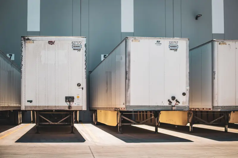 White dry van trailers backed into loading dock doors